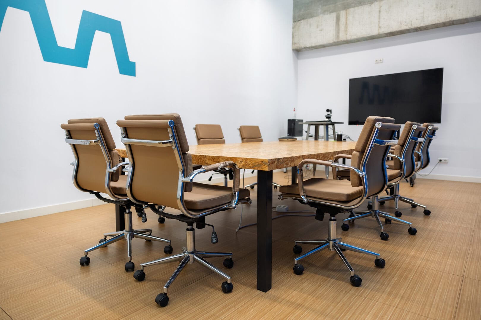 Mesa de oficina con varias sillas vacías alrededor que representa el trabajo en remoto